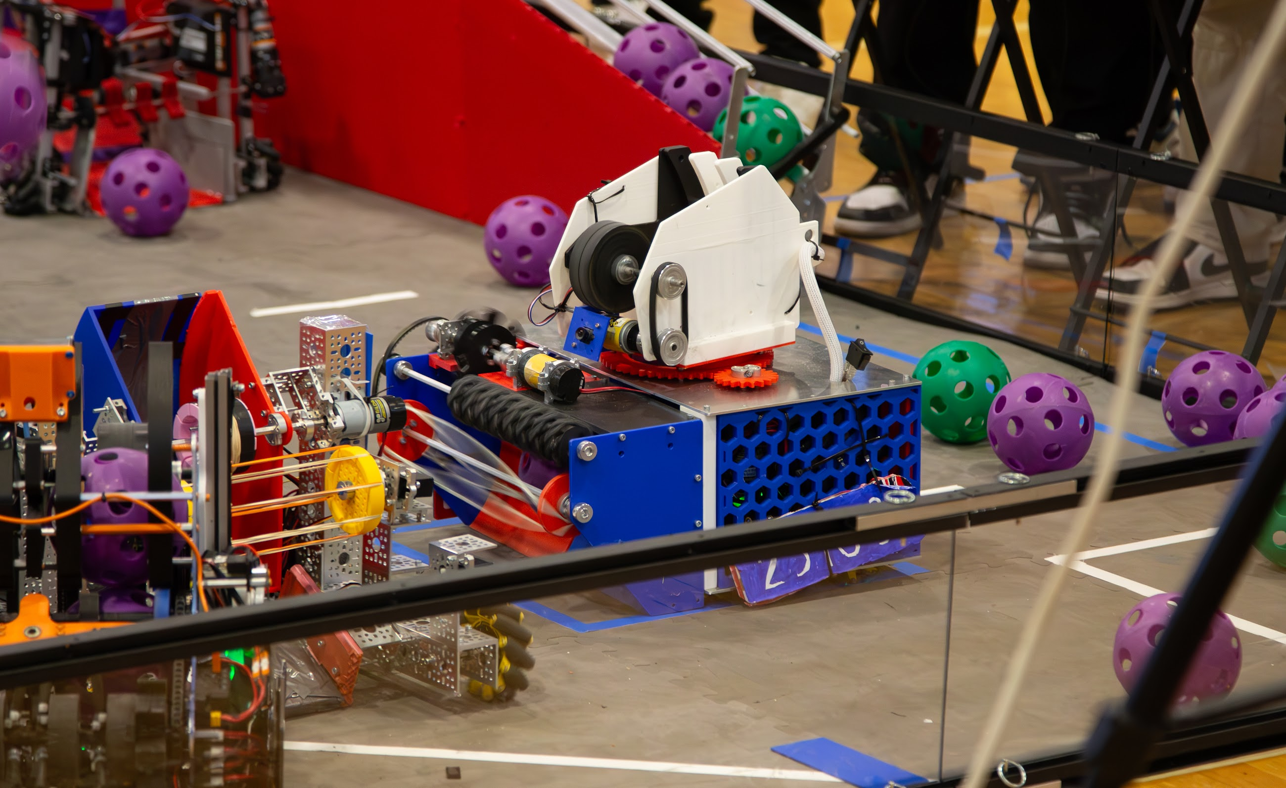 Version one FTC robot on the DECODE field surrounded by purple and green artifacts
