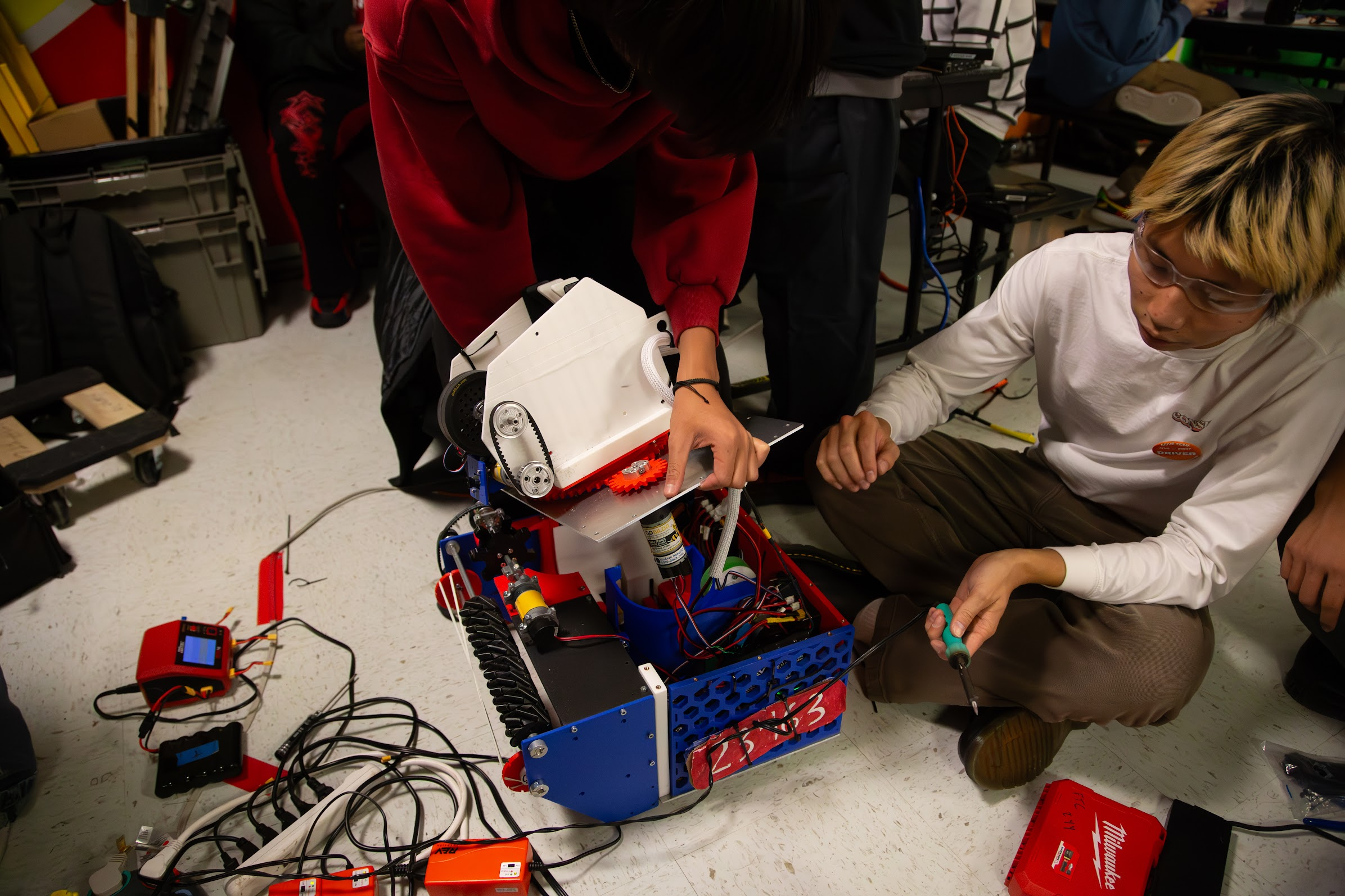 FTC team members repairing and rewiring version one of the robot